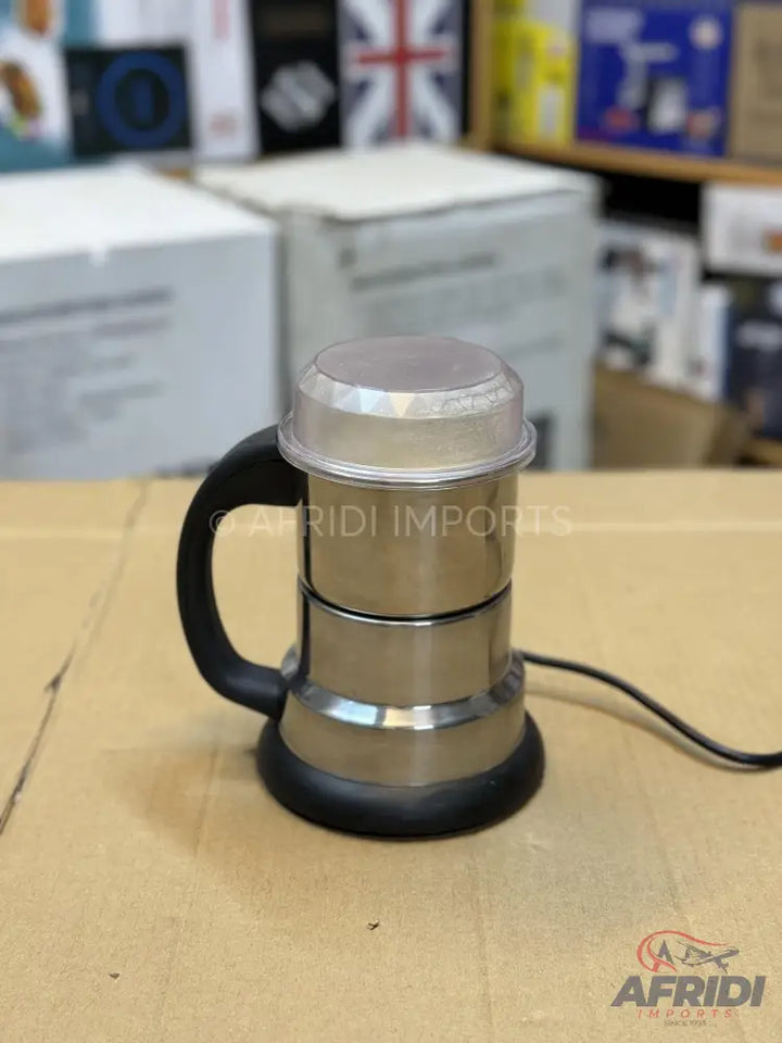 A stainless steel electric coffee grinder with a black handle and a transparent lid.