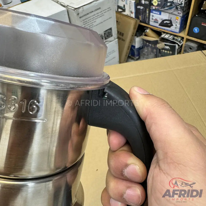A stainless steel mixing jar with a black handle and a clear plastic lid.