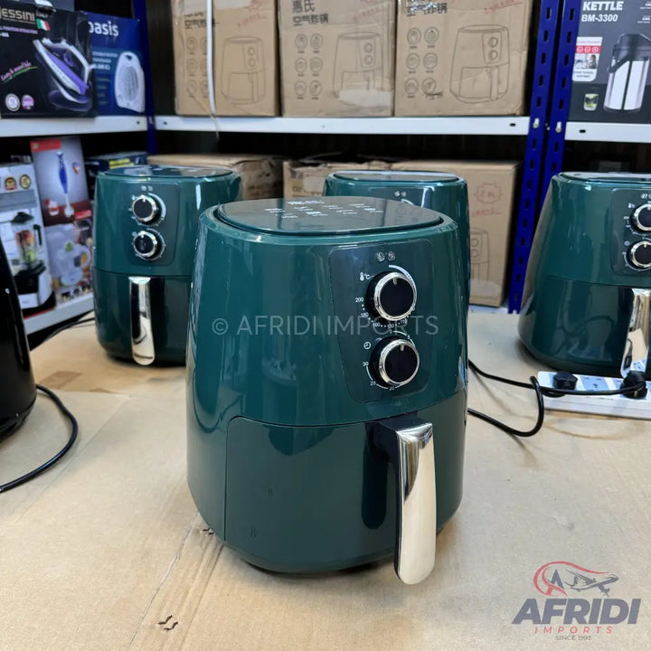 Dark green air fryer with two control knobs and a silver handle.