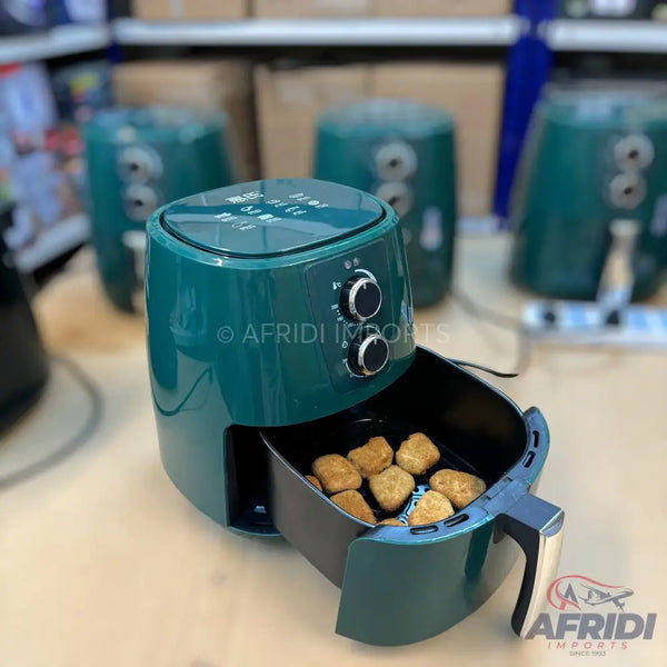 Dark green air fryer with a basket of golden-brown nuggets.