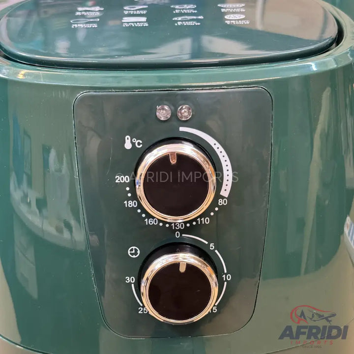 Dark green air fryer with temperature and timer dials.