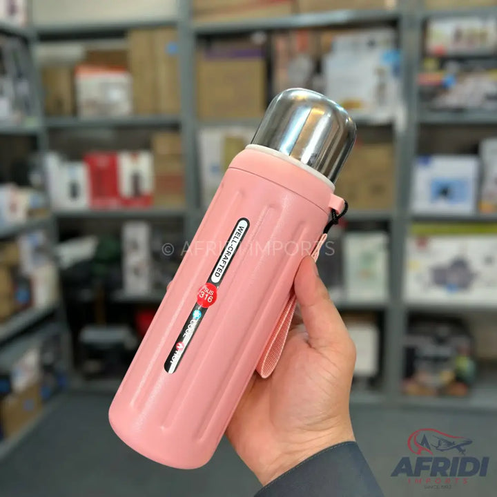 A pink thermal water bottle with a stainless steel cap and a carrying strap.