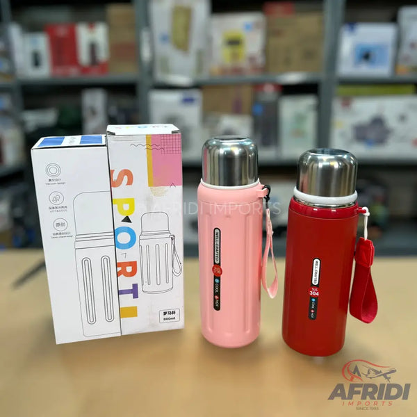 Two insulated water bottles in pink and red, with accompanying packaging.