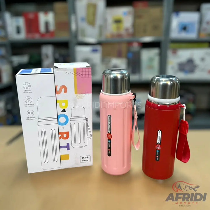 Two insulated water bottles in pink and red, with accompanying packaging.