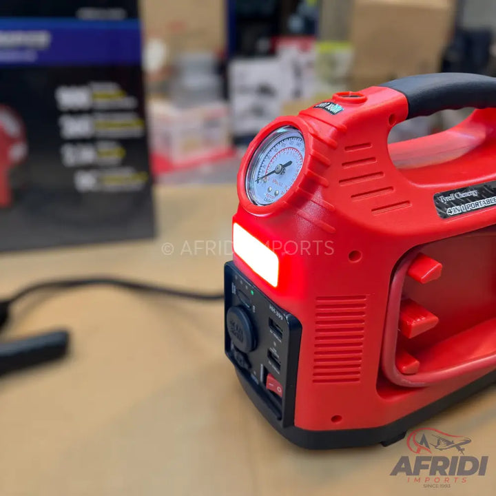 Red portable jump starter and air compressor with a pressure gauge and multiple power outputs.