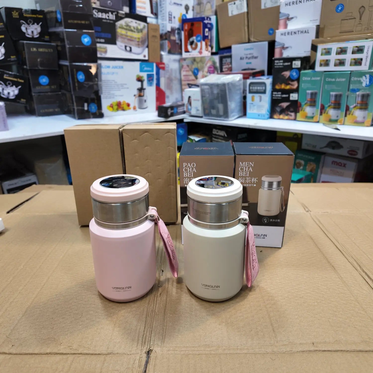 Two insulated travel mugs with digital temperature displays in pink and beige, part of the Lot Imported 800ml Mini Bottle collection.