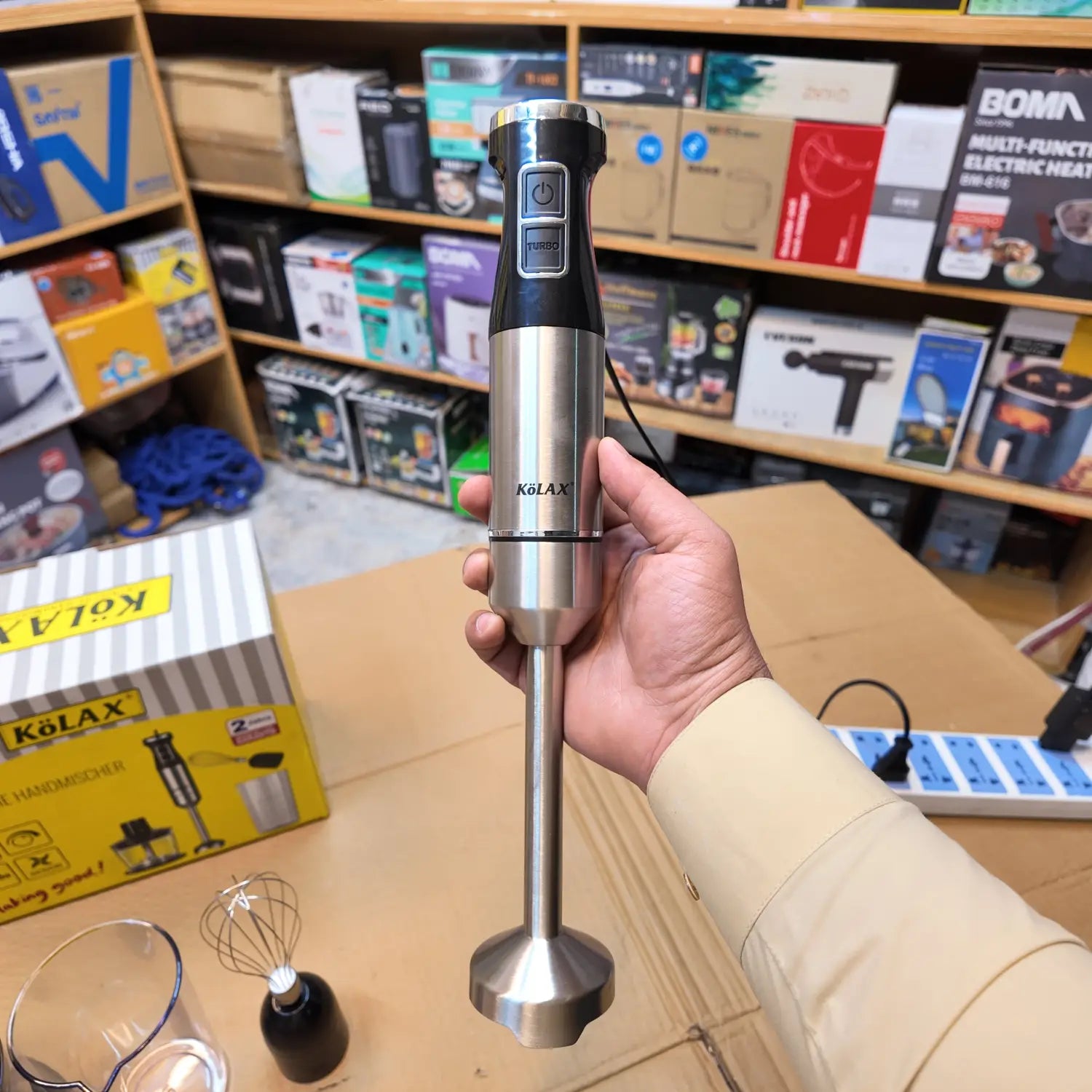 Silver and black imported Kolax 1000W hand blender with stainless steel design and control buttons