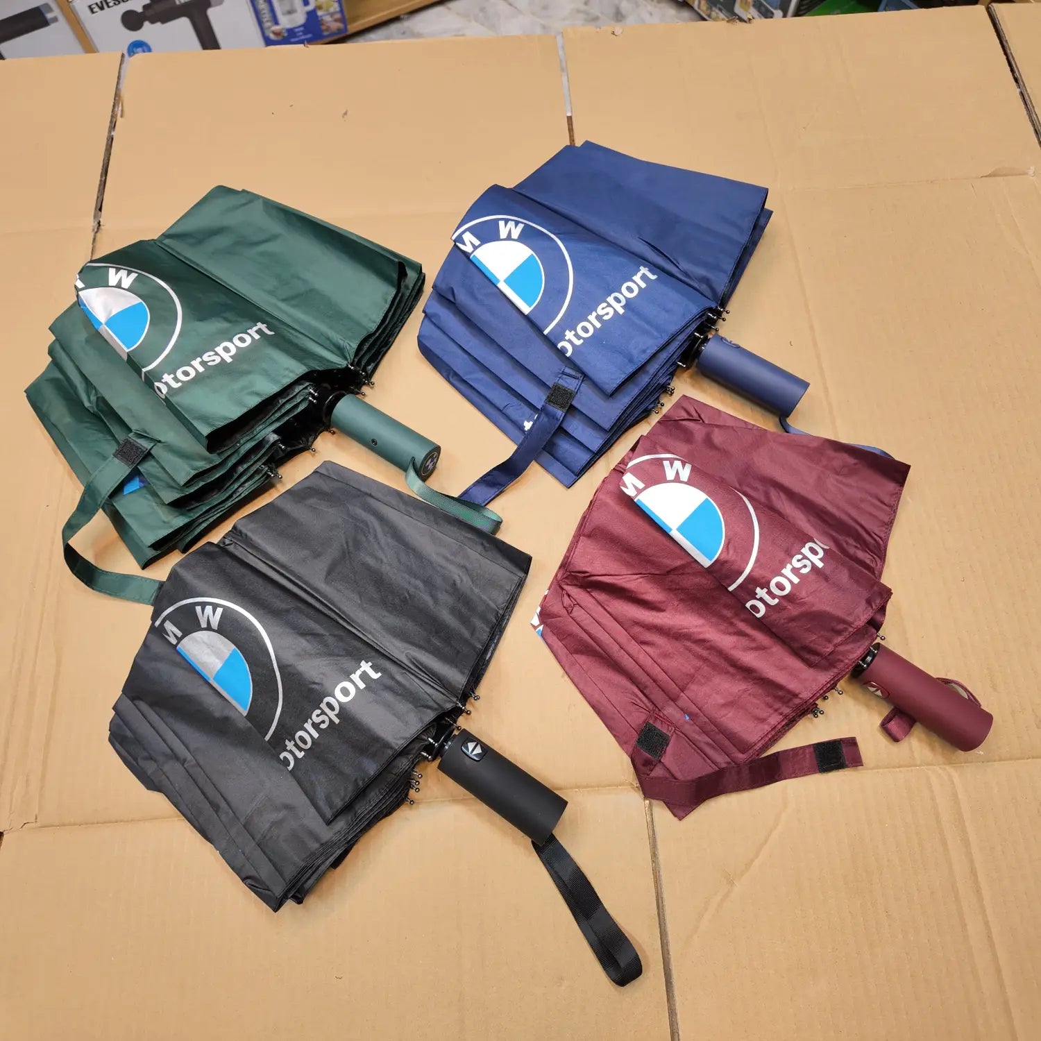 Four folded Lot Imported Folding BMW automatic umbrellas in green, blue, black, and maroon