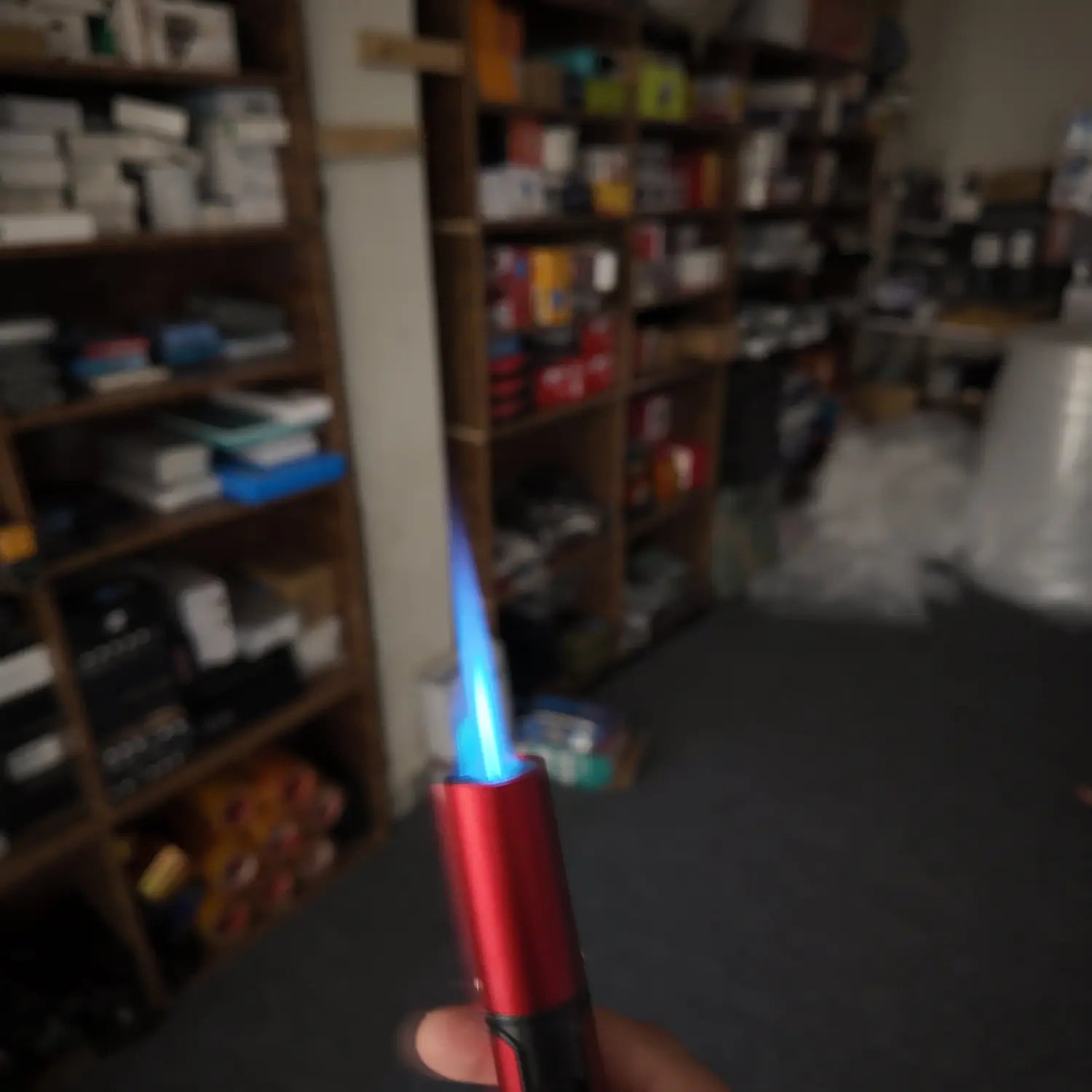 Red metal butane torch lighter with a blue jet flame from Lot Imported Honest Jet Flame Lighter