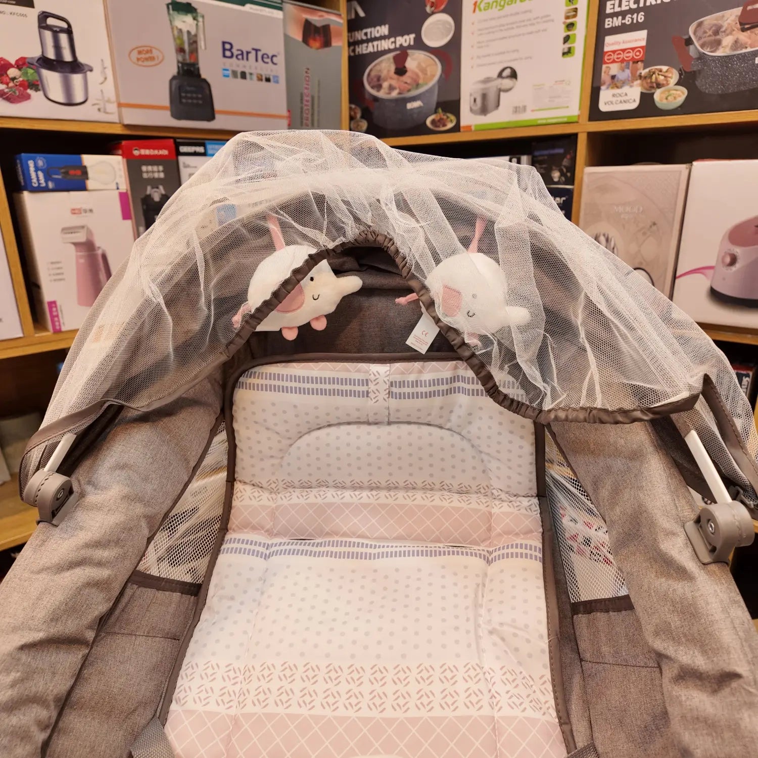 Brown and pink baby bassinet with mesh canopy and hanging elephant toys for Mastela Electric Baby Swing