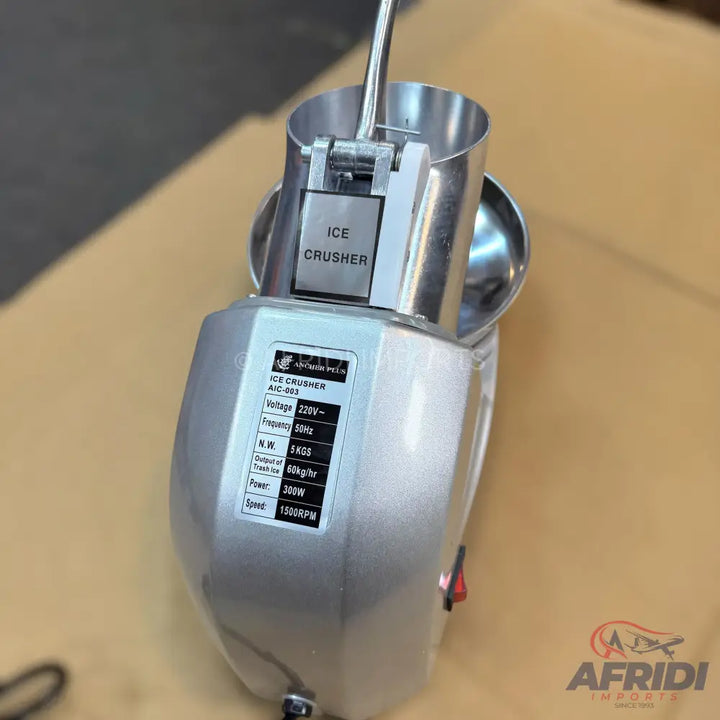 Silver electric ice crusher with a metal hopper and lever.
