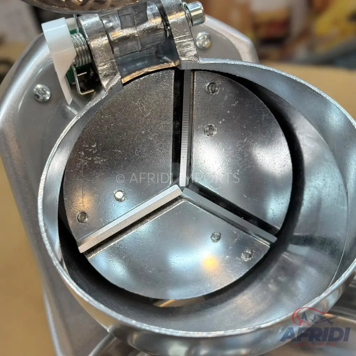 Stainless steel food processor with a three-blade cutting mechanism.