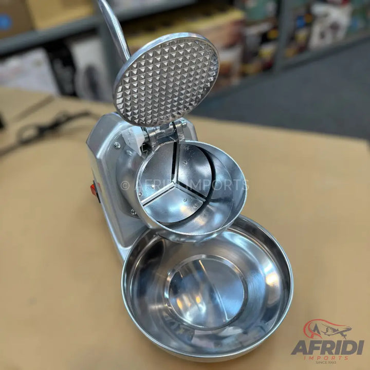Stainless steel manual ice crusher with a textured press and collection bowl.