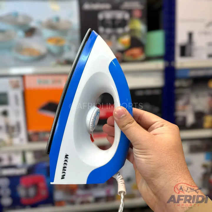 A white and blue electric dry iron with a temperature control dial.