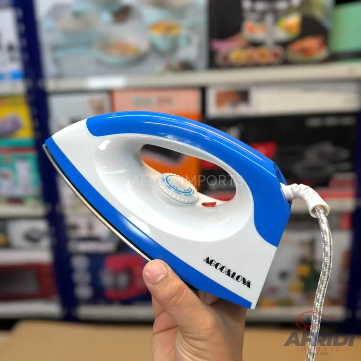 Blue and white electric clothes iron with temperature dial.