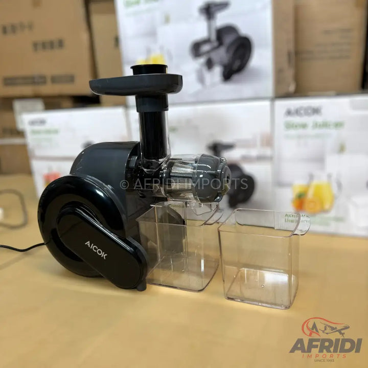 A black slow juicer with two clear collection containers.