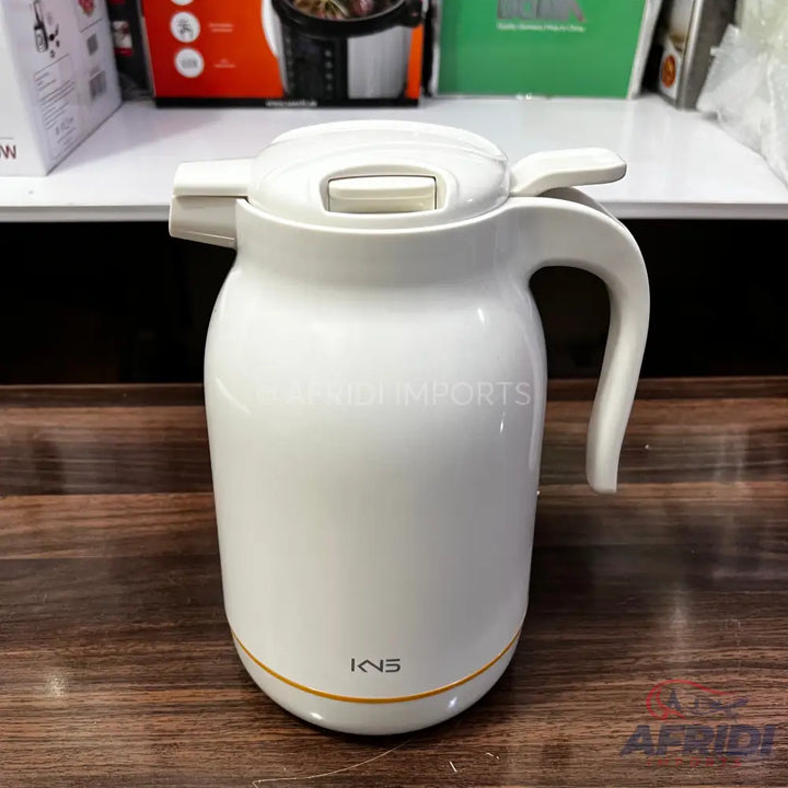 White electric kettle with a handle and lid.