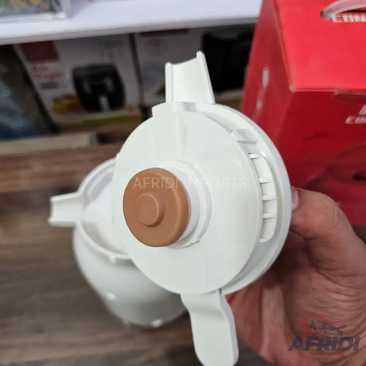 White plastic water filter housing with a brown central button.