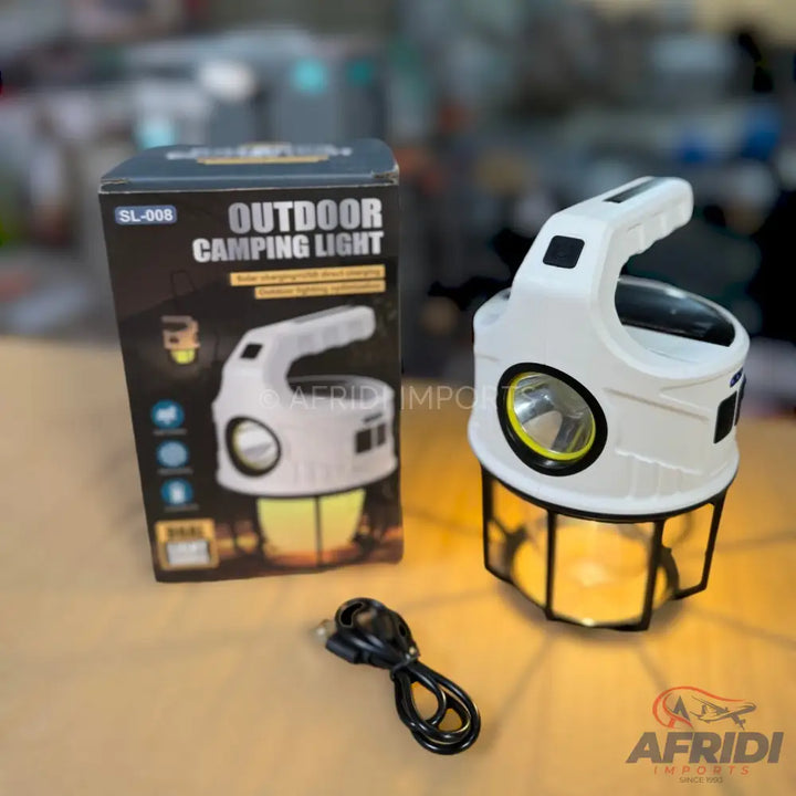 White multi-function outdoor camping lantern with a top handle and a base that emits a warm yellow light.