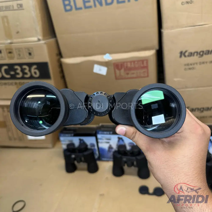Black binoculars with green-coated lenses.