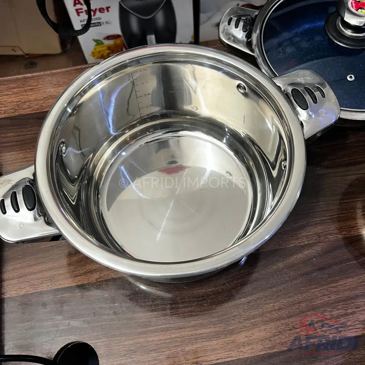 Stainless steel cooking pot with measurement markings.