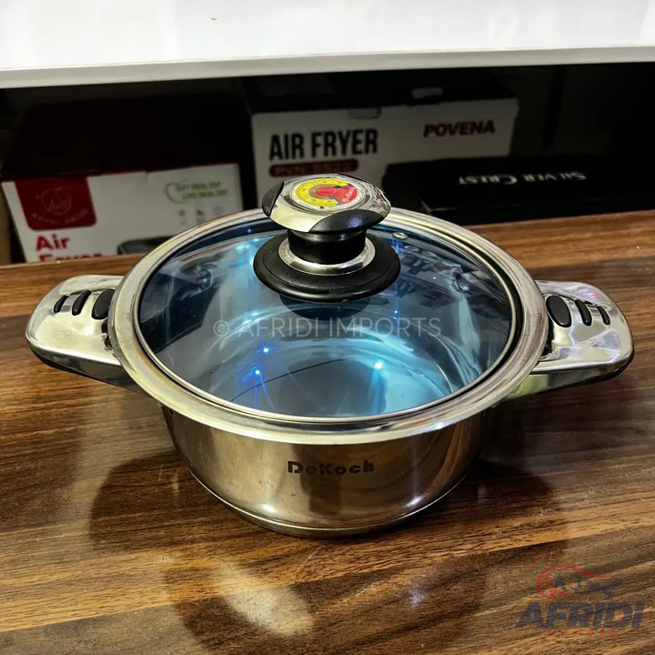 Stainless steel cooking pot with a glass lid.