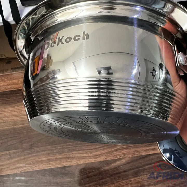 Shiny stainless steel cooking pot with a thick, ridged base.