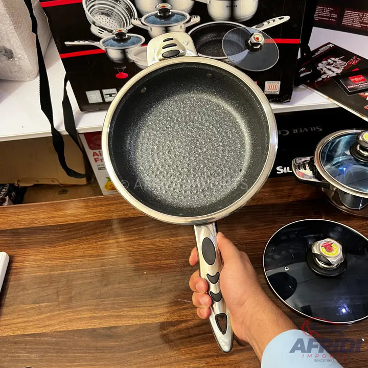 A non-stick frying pan with a textured interior and a silver and black ergonomic handle.