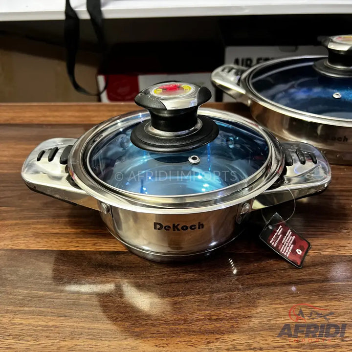 Stainless steel cooking pot with a glass lid and side handles.