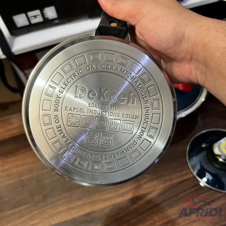 The underside of a stainless steel cooking pot, compatible with various heat sources and dishwasher safe.