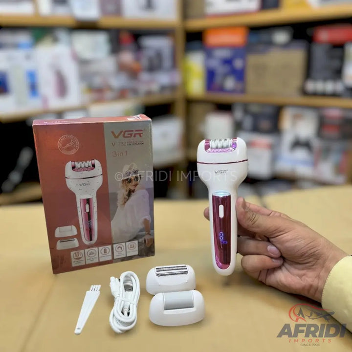 A white and pink electric epilator with multiple interchangeable heads and a charging cable.