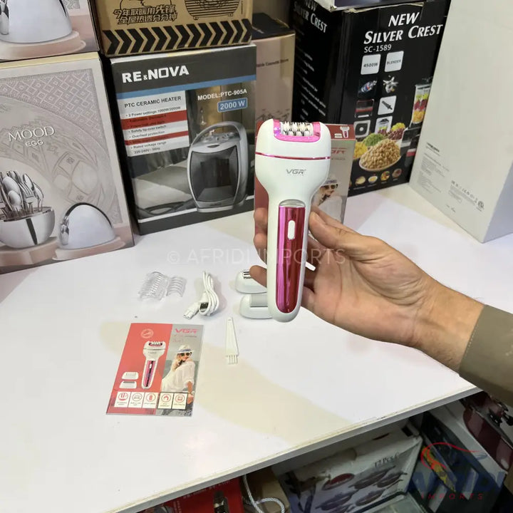 White and pink handheld electric epilator with multiple attachments.