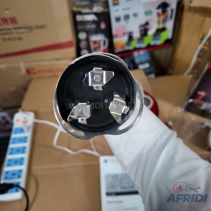 Electric blender base with a three-pronged coupler.