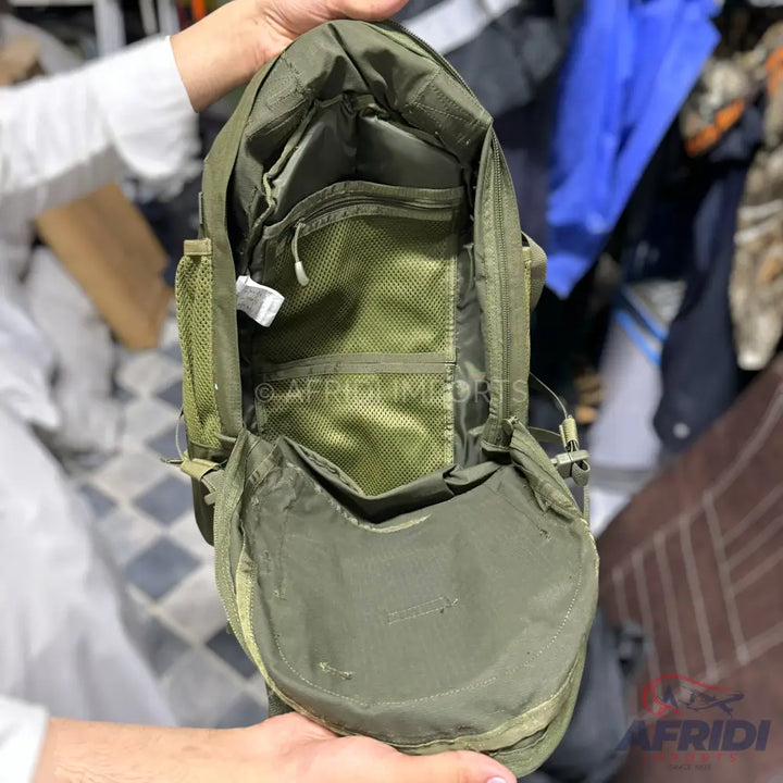Olive green backpack with multiple internal mesh and zippered pockets and an open main compartment.