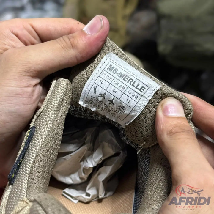 A shoe with a size tag displaying UK size 10, EUR size 44, and US size 11.