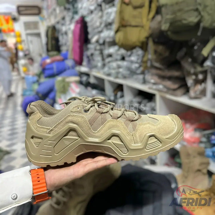 Light brown outdoor hiking shoe with a rugged sole.