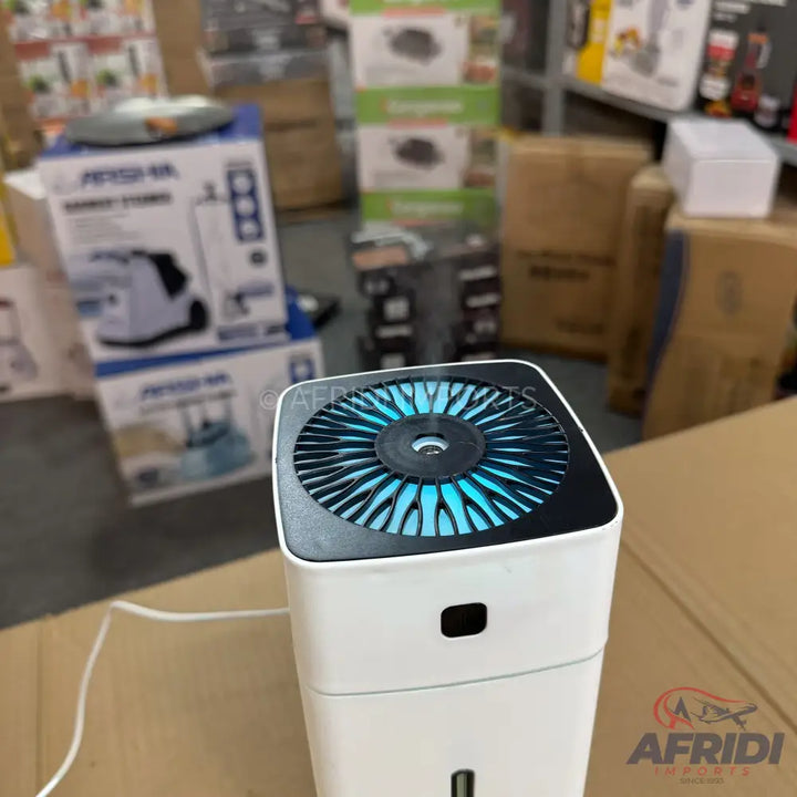 White portable air humidifier with a blue illuminated fan and mist outlet.