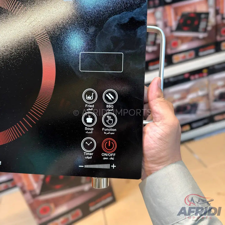 Black portable induction cooktop with touch controls and pre-set cooking functions.