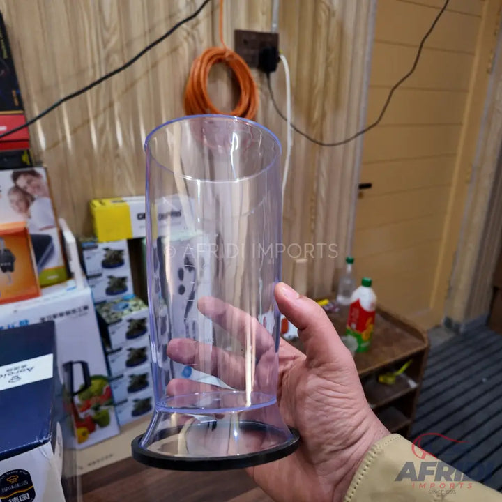 Clear plastic blending beaker with a black non-slip base.