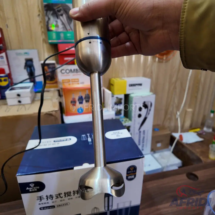 Stainless steel immersion blender with a long shaft.