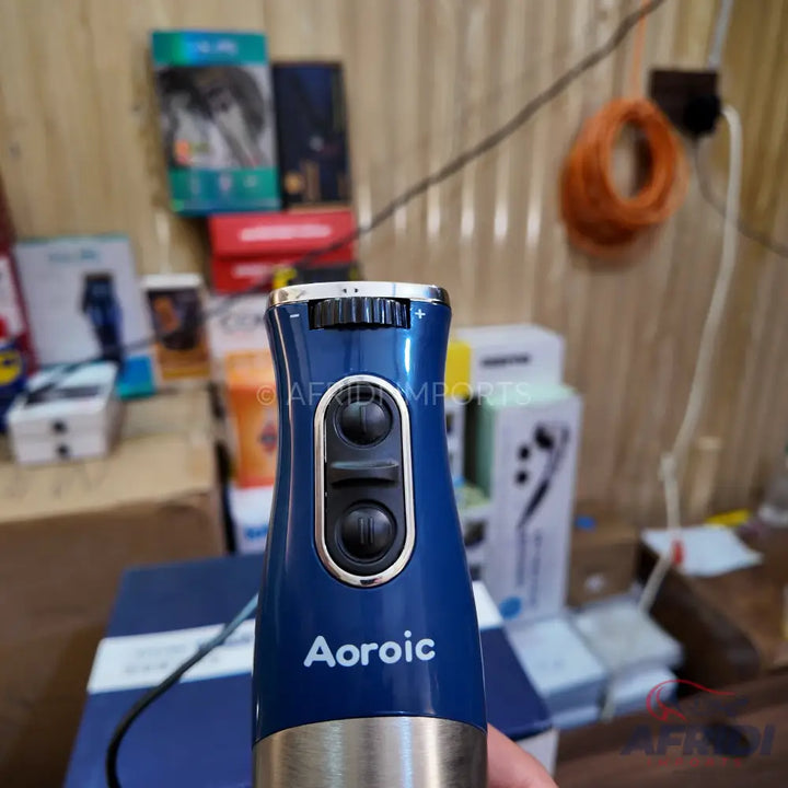 A blue and silver handheld blender with two speed buttons and a top dial for variable settings.