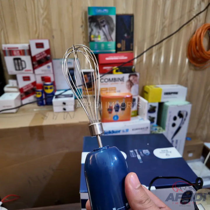 Blue handheld electric whisk with a stainless steel attachment.