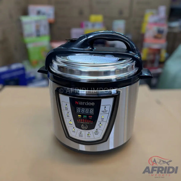 A modern, stainless steel electric pressure cooker with a black lid and an illuminated digital display.