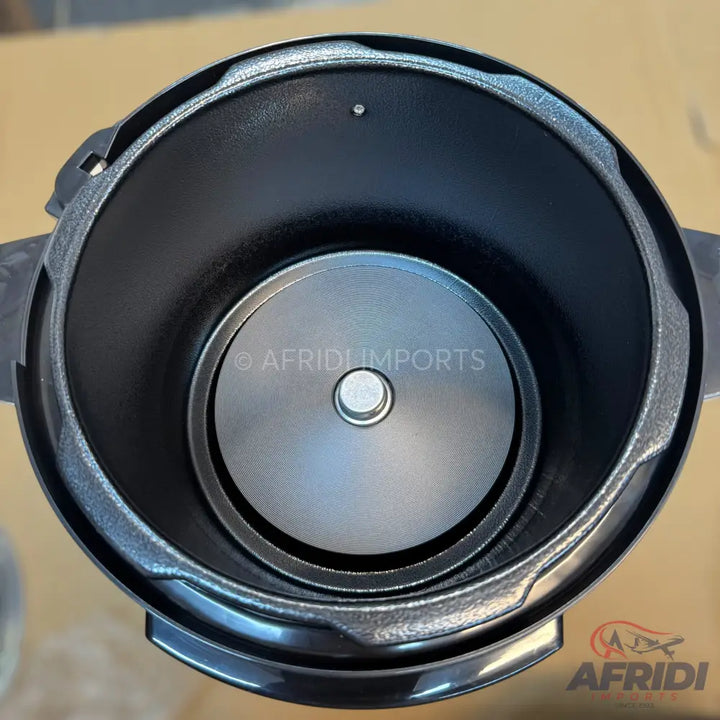An overhead view of a black electric pressure cooker with a removable non-stick inner pot.