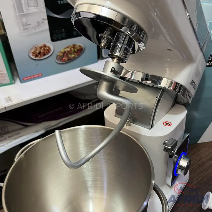 White stand mixer with a stainless steel mixing bowl and dough hook attachment.