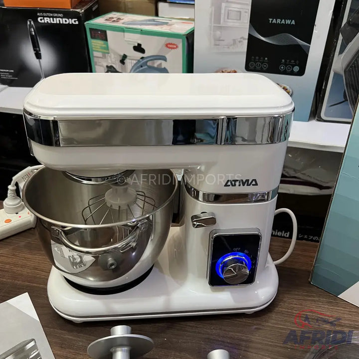 White stand mixer with a stainless steel bowl and whisk attachment.
