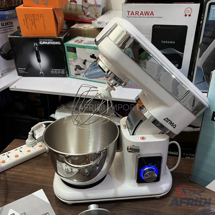 White stand mixer with a stainless steel bowl and whisk attachment.