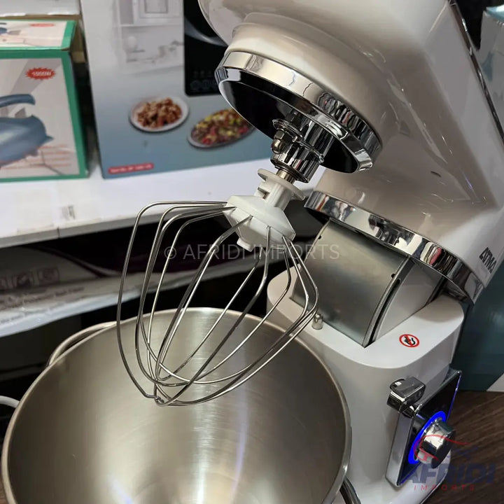 White stand mixer with a stainless steel bowl and whisk attachment.