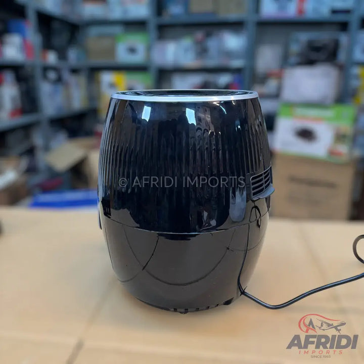A shiny black, barrel-shaped air fryer with a textured upper body.