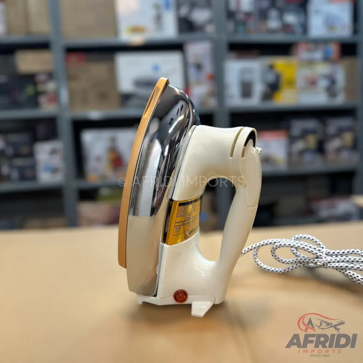 Cream-colored electric dry iron with a shiny metal soleplate and a red indicator light.